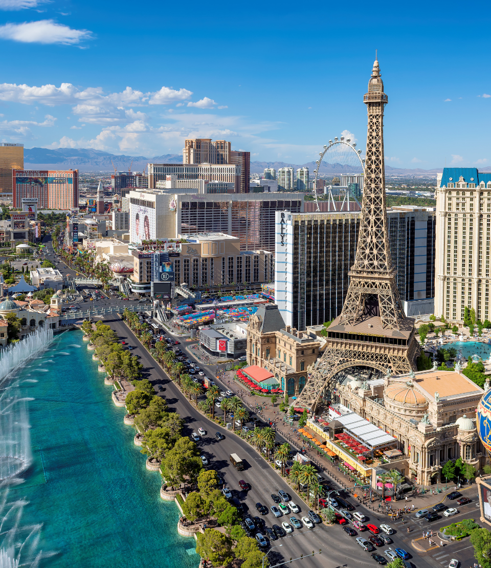 Aerial view of the Eiffel Tower, mountains, and Las Vegas strip highlighting travel insurance for Las Vegas trips