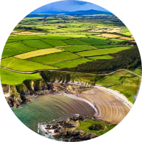 Aerial view of green fields and beach at Copper Coast for travel insurance for Ireland page