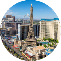 Aerial view of the Eiffel Tower, mountains, and Las Vegas strip highlighting travel insurance for Las Vegas trips