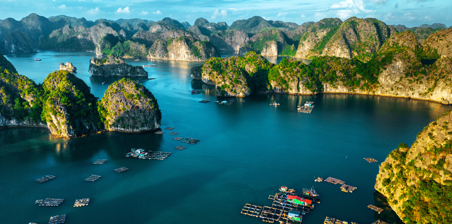 Aerial view of Ha Long Bay with boats and hills highlighting travel insurance for Vietnam trips