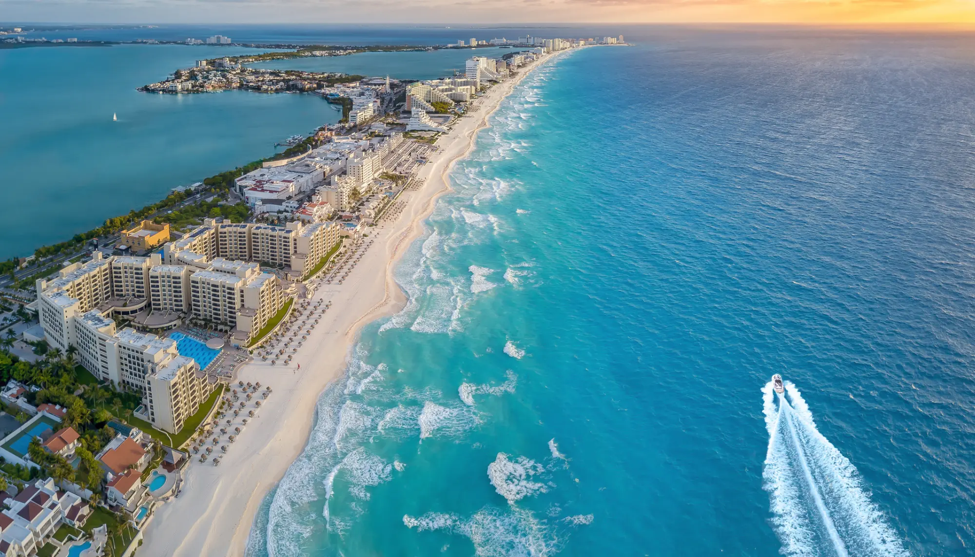 Aerial view of buildings, the beach, and the ocean in Cancun, highlighted in Travelex's Mexico travel guide