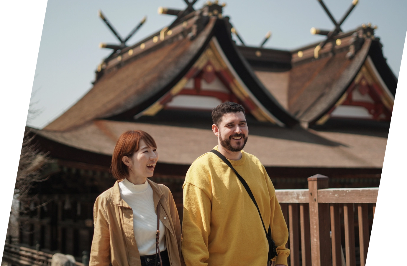 a couple with travel insurance for Japan, holding hands as they walk through an ancient Japanese town