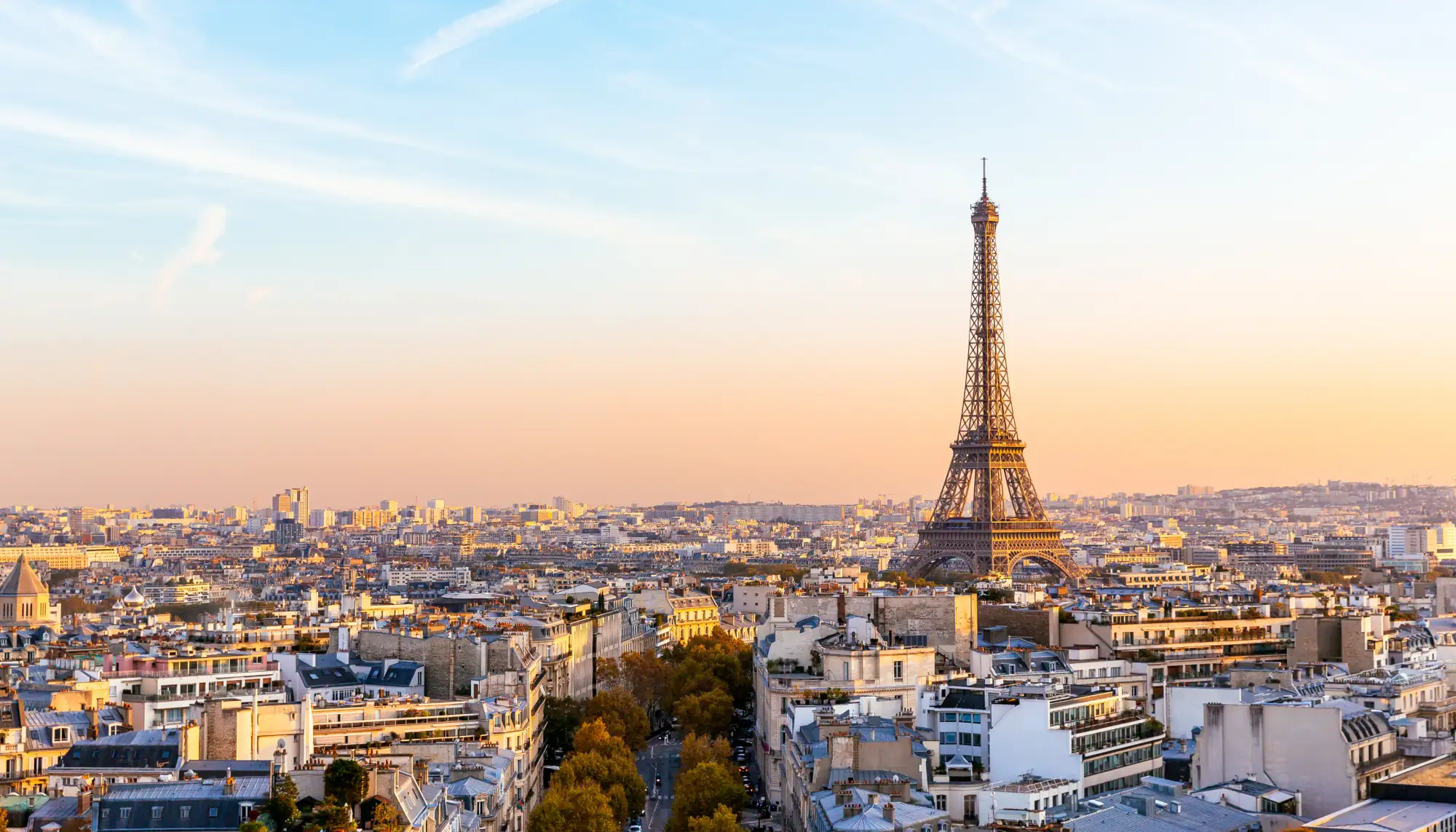 Panoramic view of the city of Paris and Eiffel Tower at sunset, highlighting our Europe travel guide