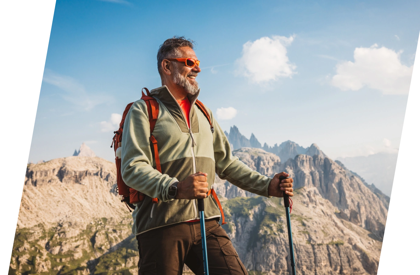 an elderly man with travel insurance for seniors, enjoying mountain views while holding hiking sticks