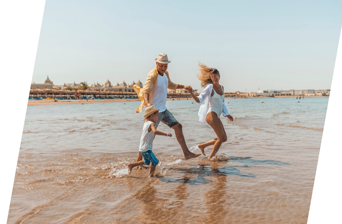 Parents and child running on the beach in Egypt with travel insurance plans