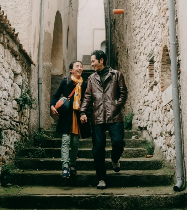 Father and teen daughter walking side by side on an alley in Villa Santa Maria with travel insurance for Italy