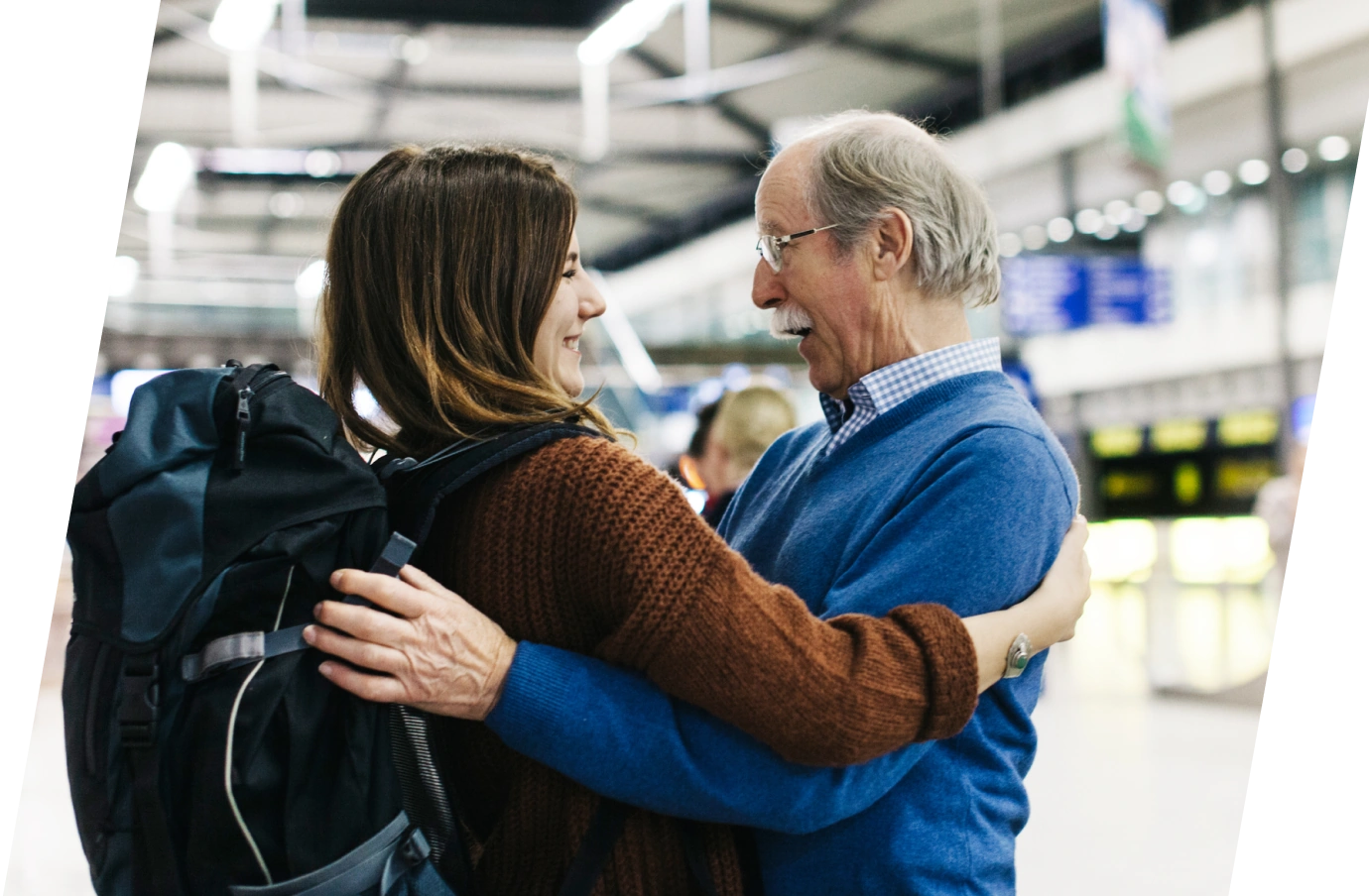 a daughter with accidental death travel insurance, hugging her father at the airport before she departs