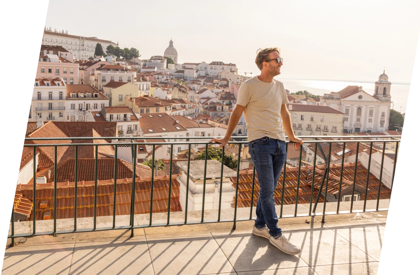 man with travel insurance for Europe, enjoying a rooftop lookout in Portugal