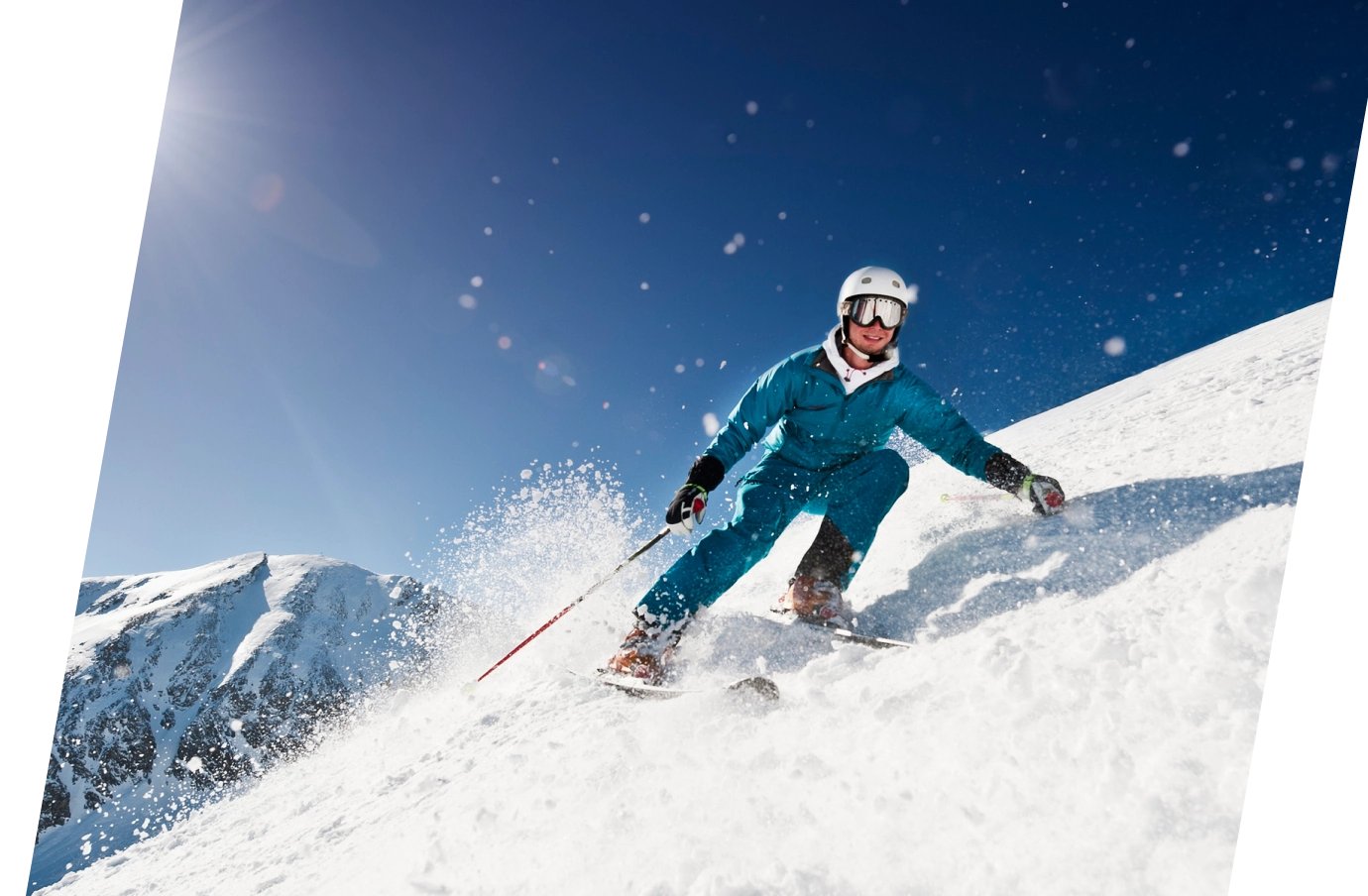 a young man in blue gear skis down a mountain on a sunny, blue-sky day, insured with ski insurance 