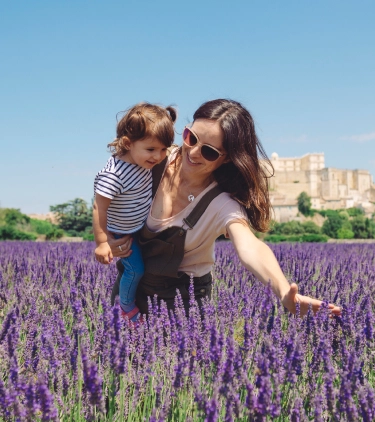mother and daughter with travel insurance for France, enjoying lavender fields in Provence  