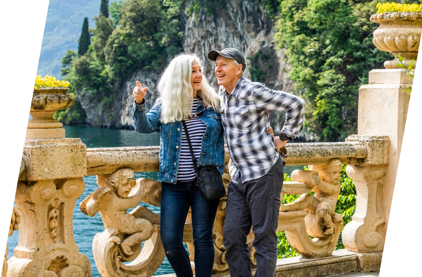 A senior couple with travel insurance for Italy sightseeing at Lake Como