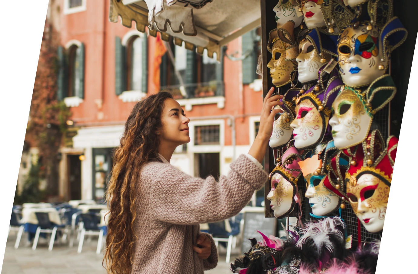Woman with travel insurance for Italy shopping for Venetian masks at an outdoor market