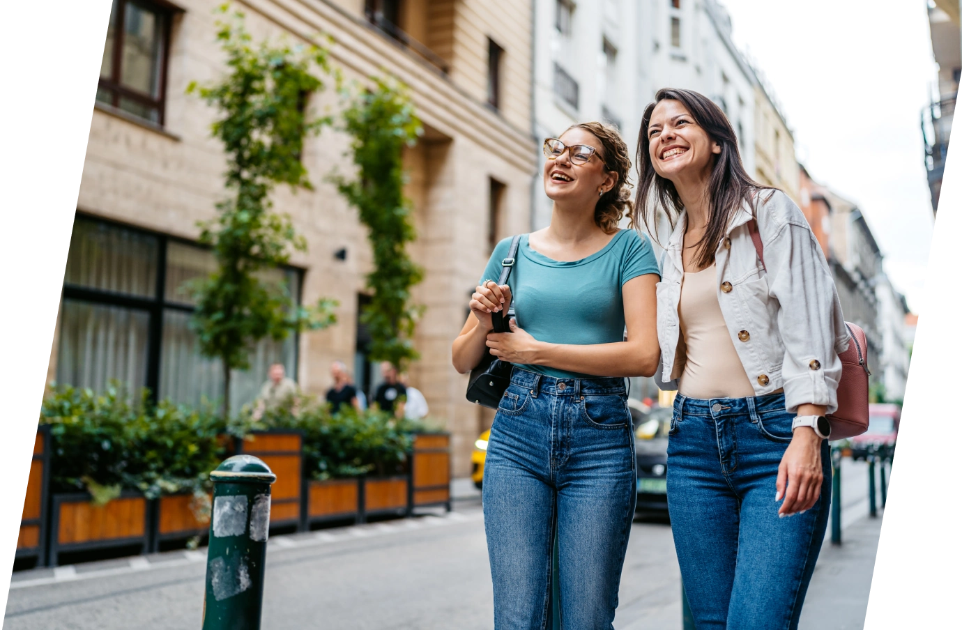 Two young women walking in town on vacation with access to Travelex customer service