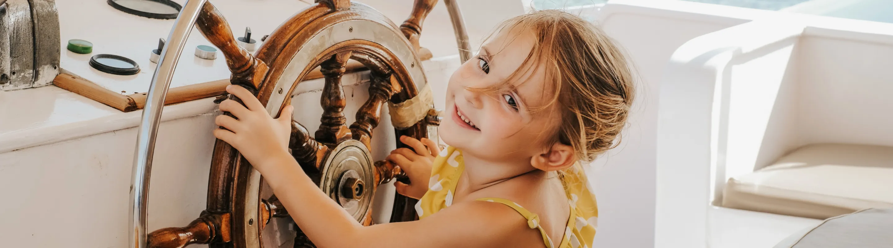 a young girl plays captain on a ship, insured with cruise travel insurance 