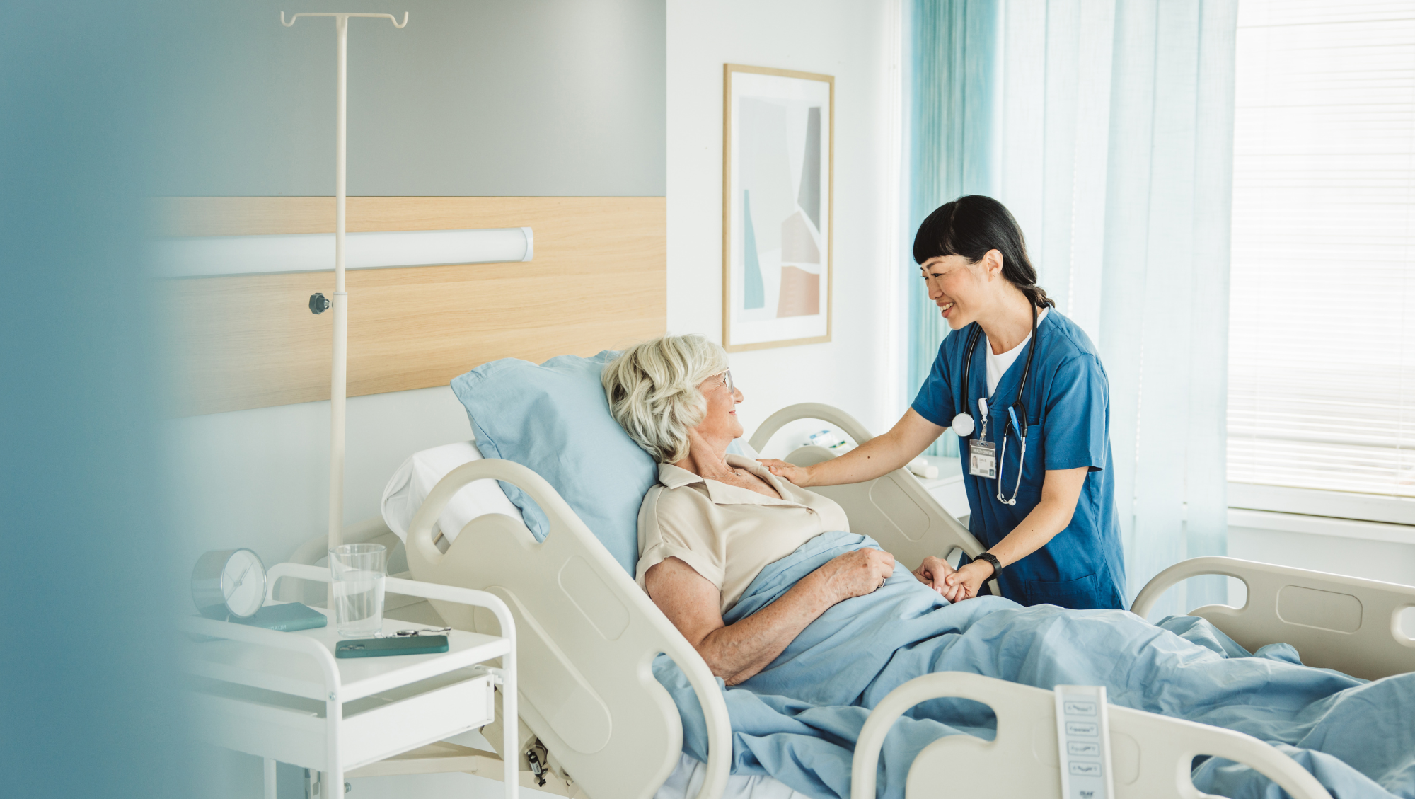 an older patient talks with a nurse in a private room while in the hospital on vacation