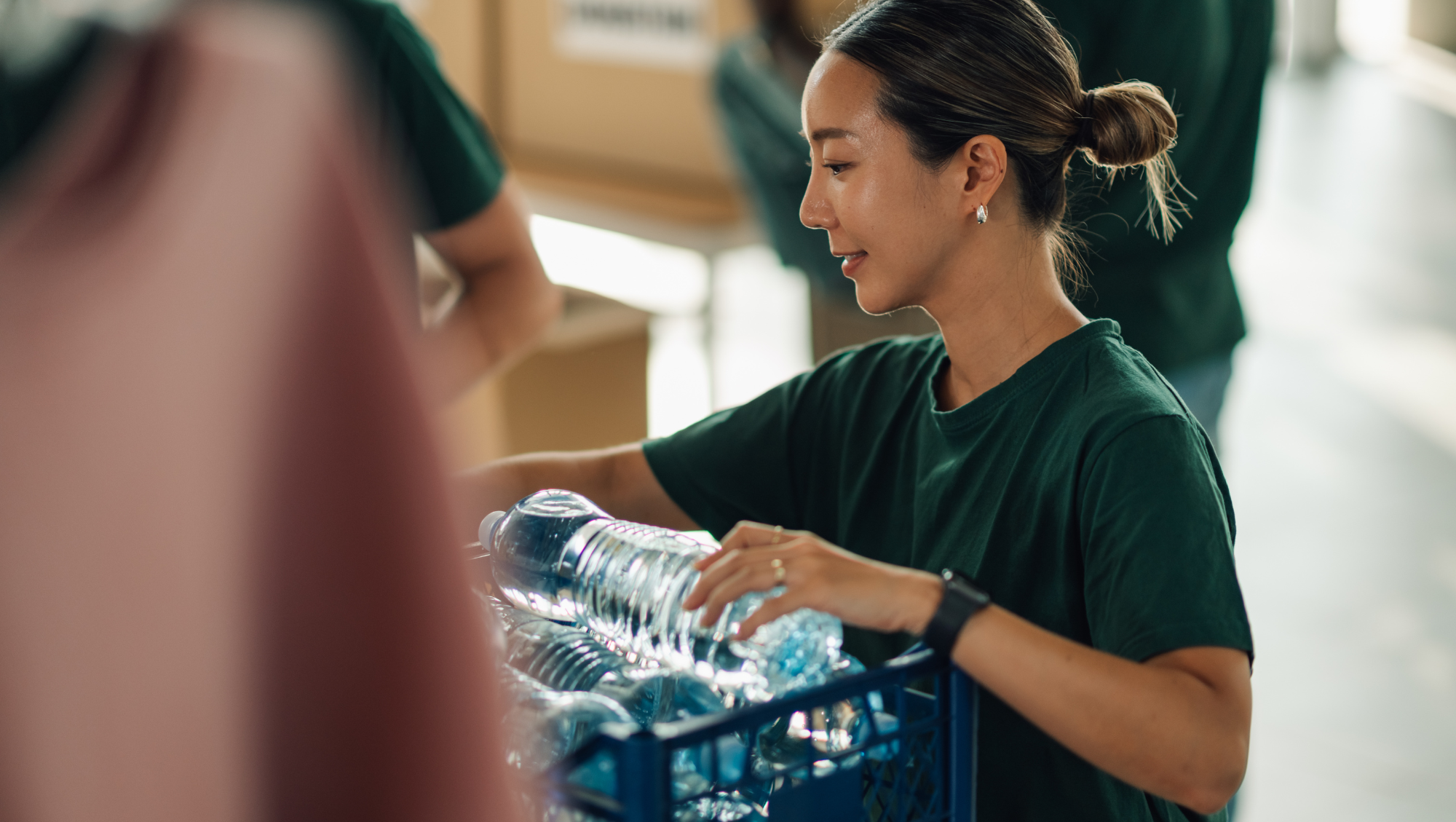 a woman organizes bottled water for disaster relief after deciding to travel during hurricane season and volunteer 