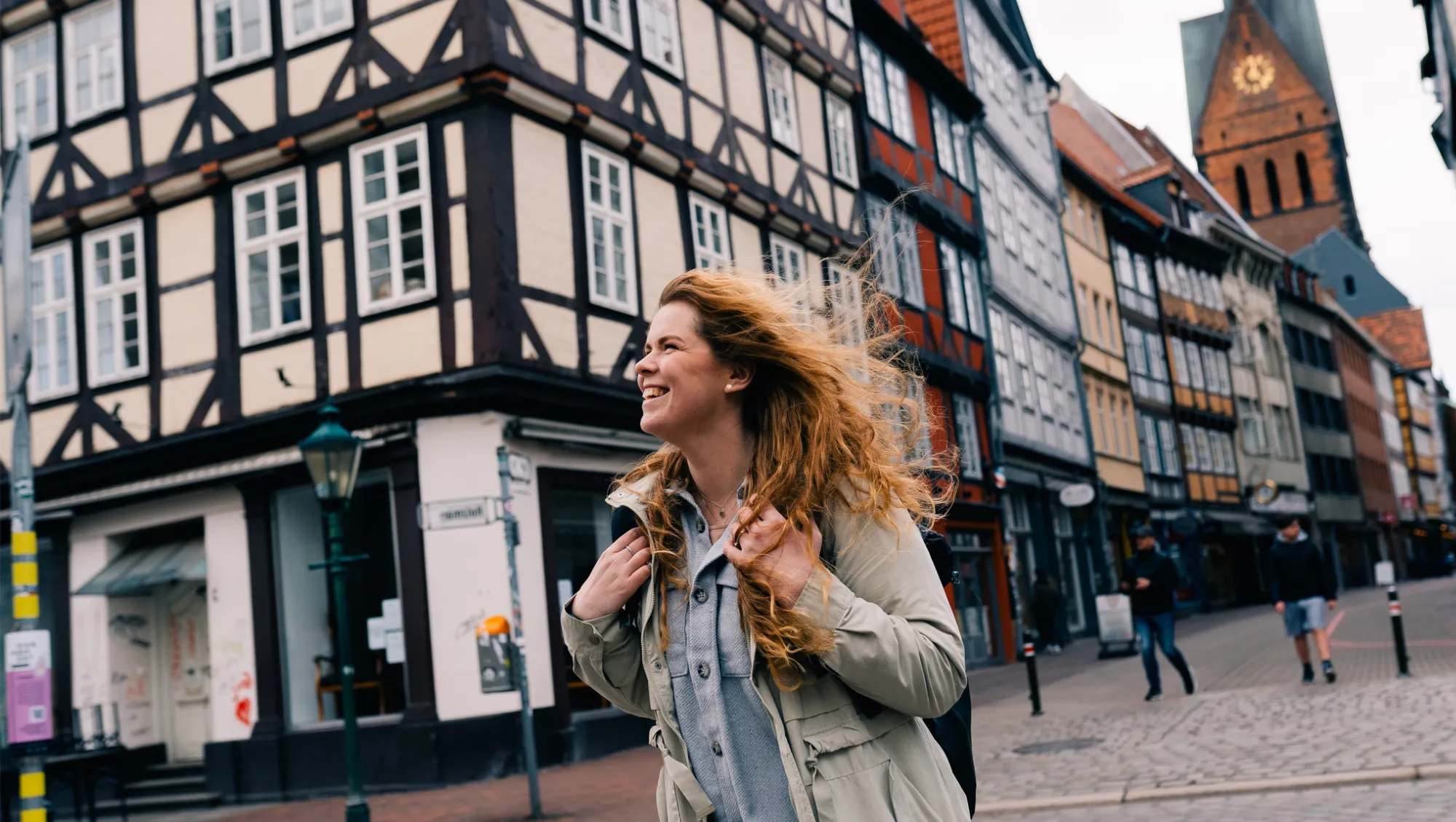 a woman explores a historic city in Germany with her travel app nearby if she needs it