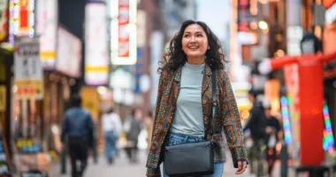 Woman strolling the streets of Japan, wondering "What do I do in an earthquake in this region?"