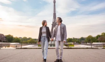 Middle-aged couple in Paris, one of the most romantic places in the world, holding hands in front of the Eiffel Tower