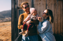Couple with baby on vacation after researching the best places to travel with a baby