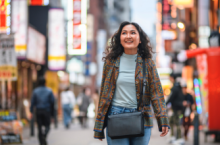 Woman strolling the streets of Japan, wondering "What do I do in an earthquake in this region?"