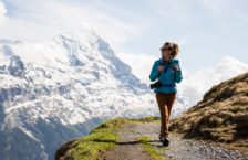Woman hiking in the mountains in Switzerland, one of the best places to travel as a solo female in the U.S. and abroad.