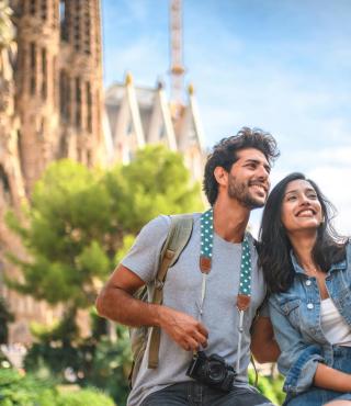 Young couple taking break from sightseeing for selfie